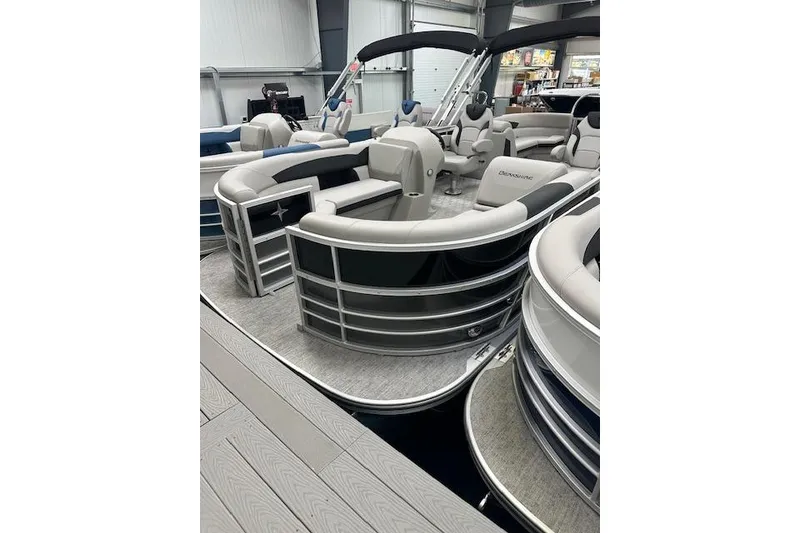 Slide: The Image of 2026 Berkshire 24RFX LE pontoon boat with sleek design and luxurious seating in showroom. - 6