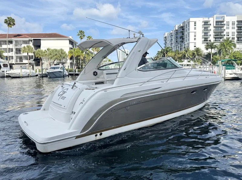 Slide: The Image of 2004 Formula 37 Performance Cruiser on calm water near dock. - 2