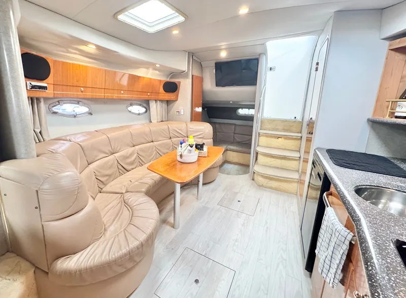 Slide: The Image of Interior of a 2004 Formula 37 Performance Cruiser with leather sofa and kitchen. - 25