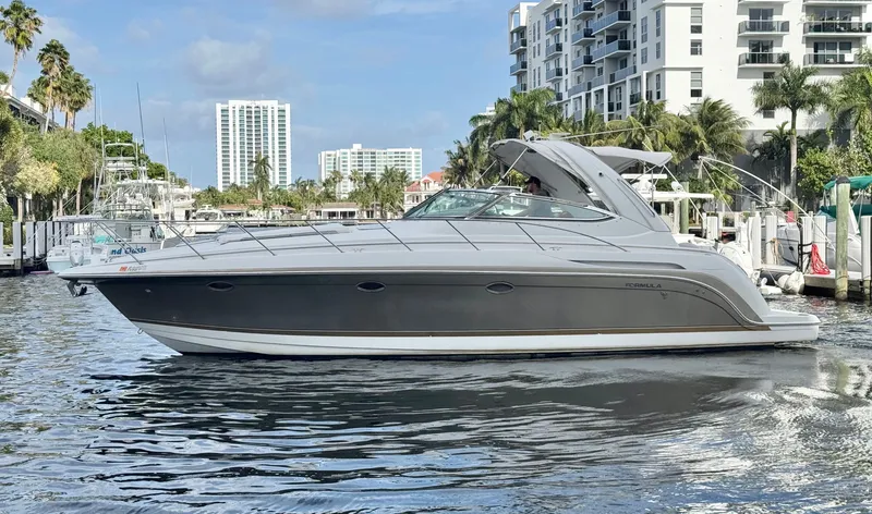 Slide: The Image of 2004 Formula 37 Performance Cruiser on water near modern buildings. - 8