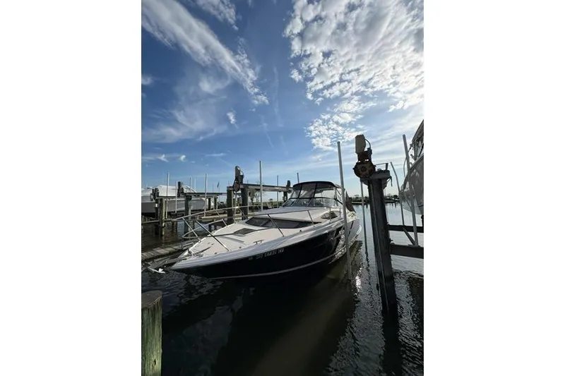 The Image of 2013 Regal 35 Express Cruiser docked under a vibrant blue sky. - 0