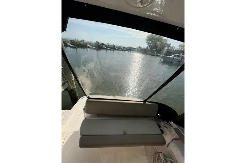 Slide: The Image of 2013 Regal 35 Express Cruiser interior view with waterfront backdrop. - 12