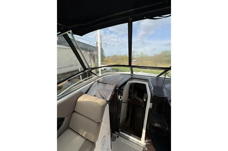 Slide: The Image of Interior view of 2013 Regal 35 Express Cruiser with seating and open cabin door. - 15