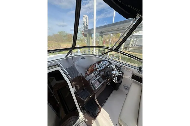 Slide: The Image of 2013 Regal 35 Express Cruiser helm with modern controls and panoramic view. - 16