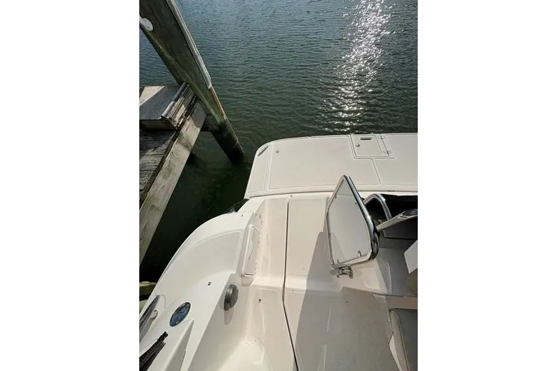 Slide: The Image of 2013 Regal 35 Express Cruiser docked, showing deck and water reflection. - 18