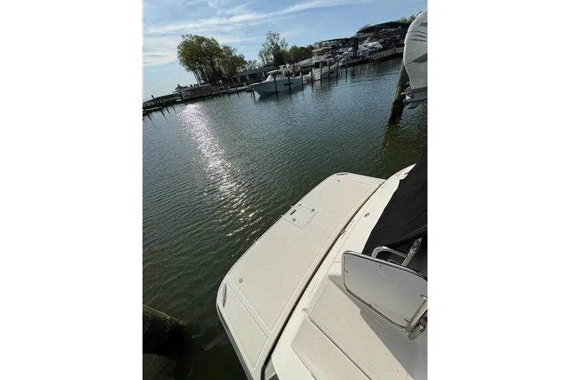 Slide: The Image of 2013 Regal 35 Express Cruiser docked at a serene marina under a sunny sky. - 19