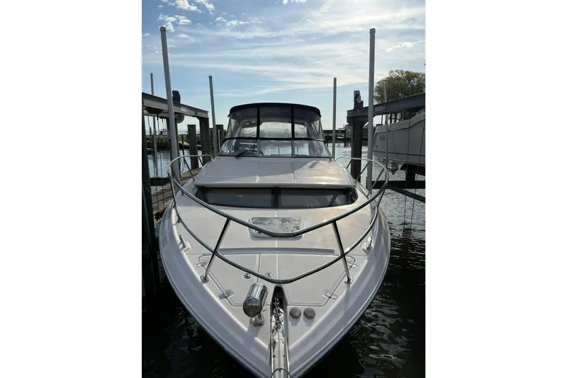 Slide: The Image of 2013 Regal 35 Express Cruiser docked, front view under a clear sky. - 2