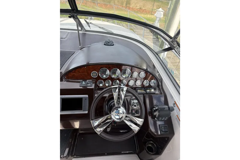 Slide: The Image of Helm of 2013 Regal 35 Express Cruiser with gauges and steering wheel. - 28