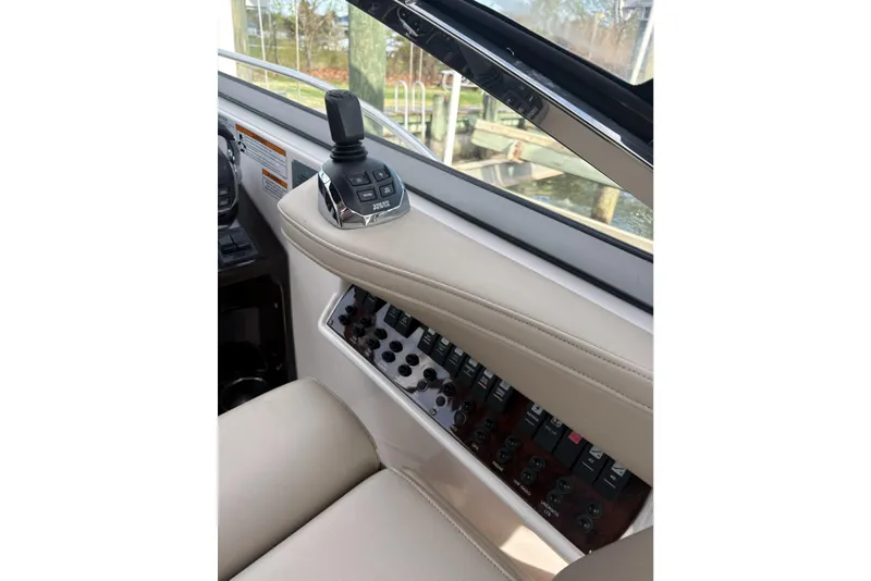 Slide: The Image of Control panel of a 2013 Regal 35 Express Cruiser with joystick and switches. - 29