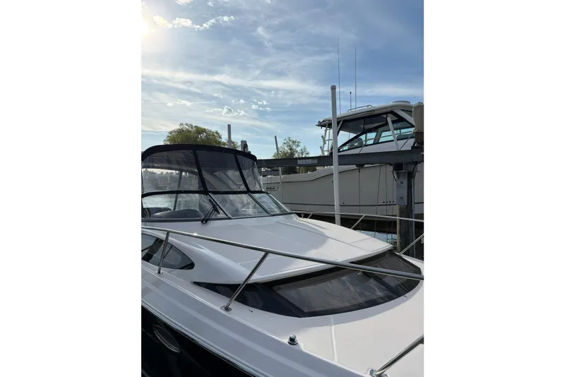 Slide: The Image of 2013 Regal 35 Express Cruiser docked under a partly cloudy sky. - 3