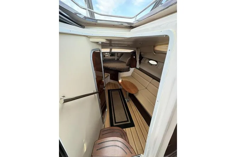 Slide: The Image of Interior view of 2013 Regal 35 Express Cruiser, featuring seating and a wooden table. - 31