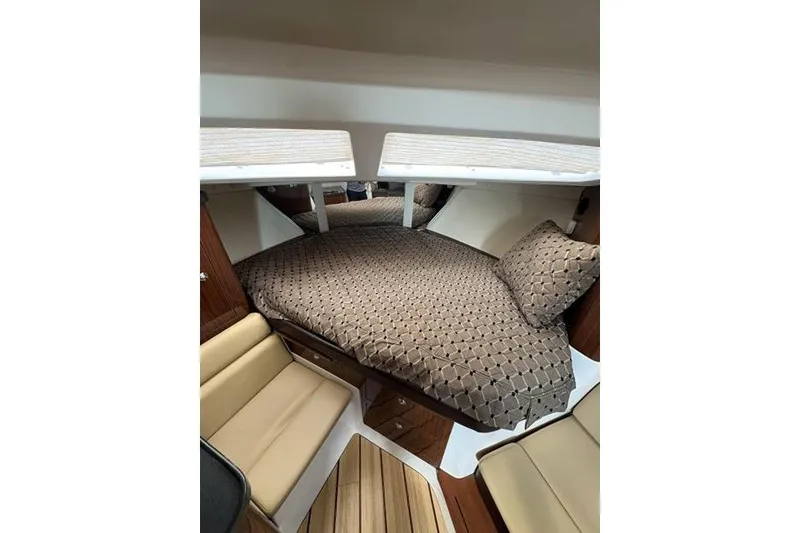Slide: The Image of Interior cabin of 2013 Regal 35 Express Cruiser with cozy bedding and seating. - 33