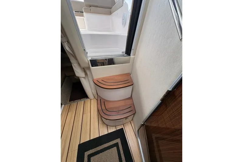 Slide: The Image of Interior steps of 2013 Regal 35 Express Cruiser with wooden finish and modern design. - 38