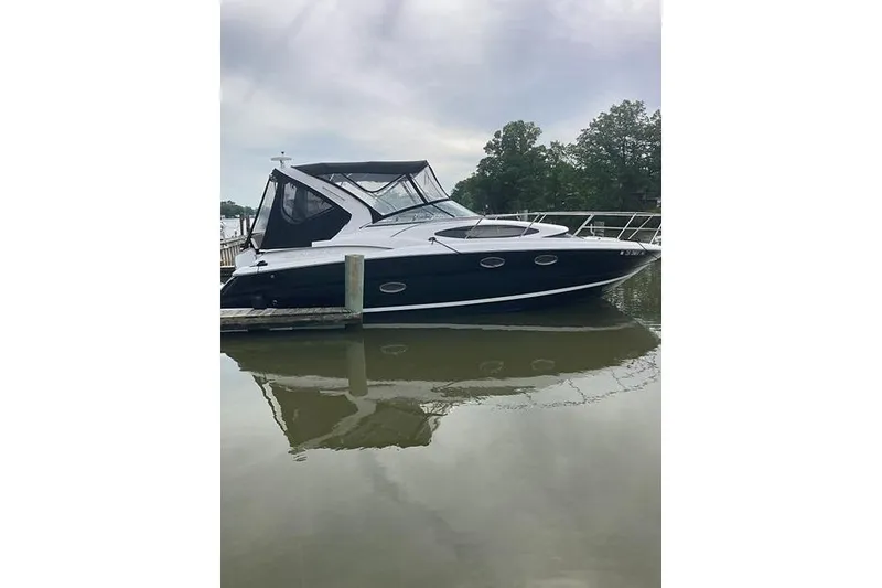 Slide: The Image of 2013 Regal 35 Express Cruiser docked on calm water, overcast sky. - 4