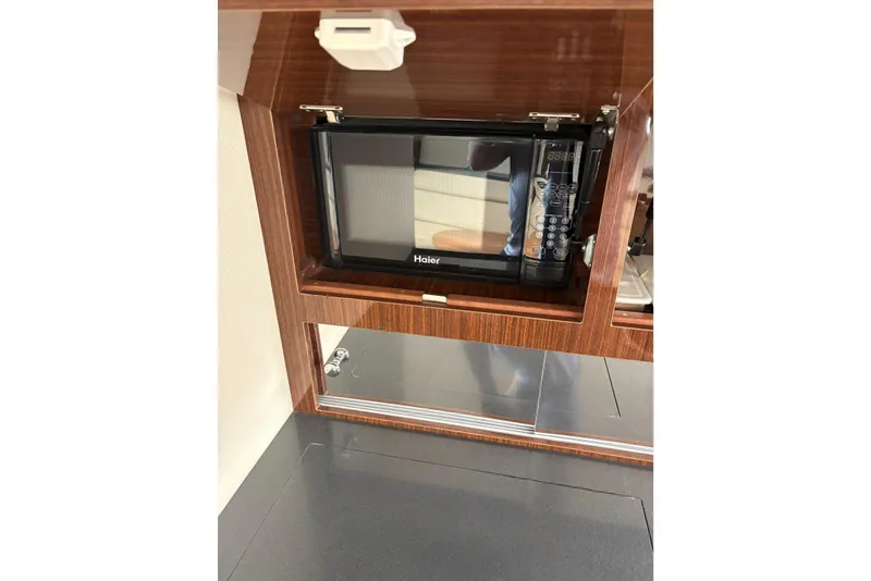 Slide: The Image of Microwave in 2013 Regal 35 Express Cruiser's wooden cabinet interior. - 40