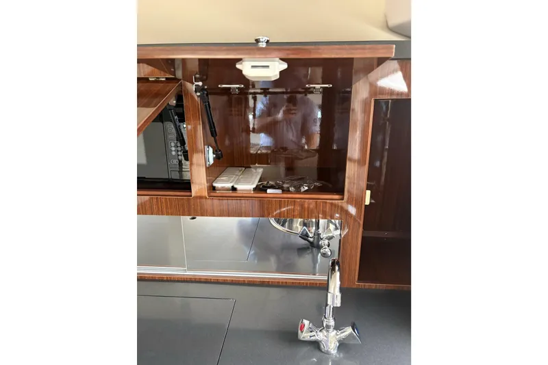 Slide: The Image of Interior of 2013 Regal 35 Express Cruiser with wooden cabinetry and modern fixtures. - 42