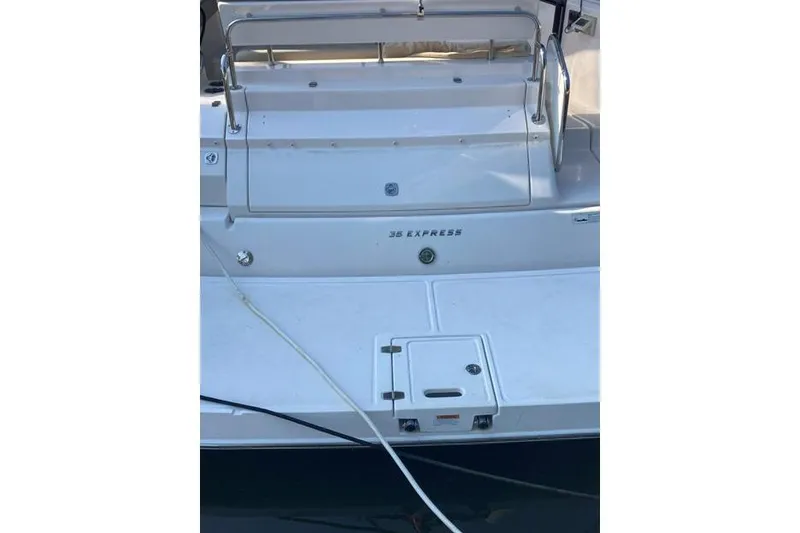 Slide: The Image of 2013 Regal 35 Express Cruiser boat deck with railing and storage hatch. - 7