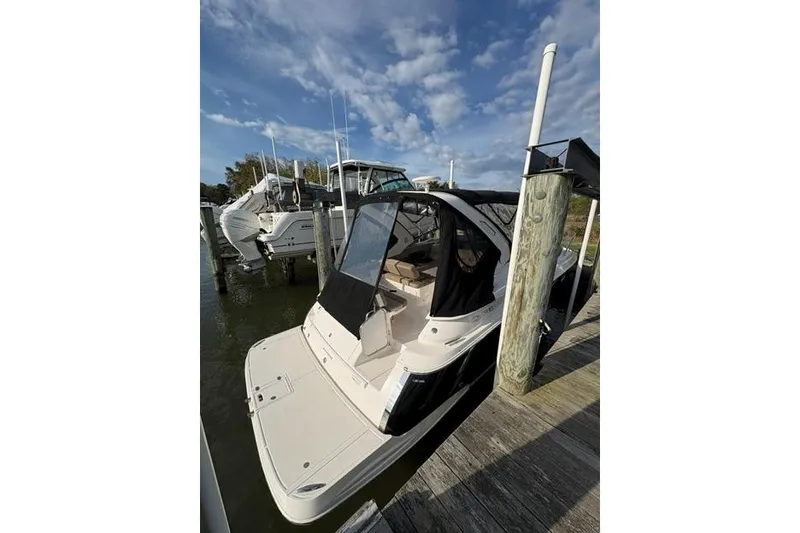 Slide: The Image of 2013 Regal 35 Express Cruiser docked at marina under blue sky. - 8