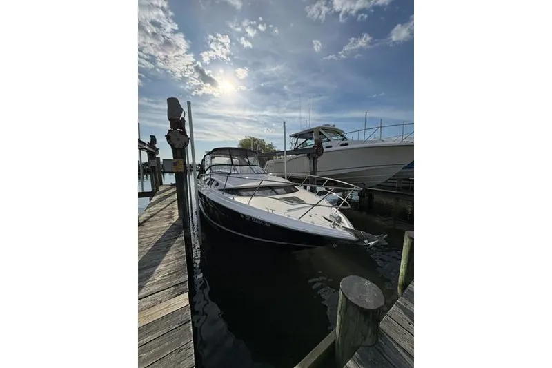 Slide: The Image of 2013 Regal 35 Express Cruiser docked under a sunny sky. - 9