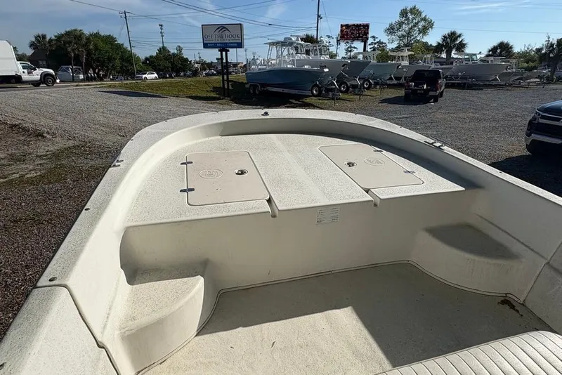 Slide: The Image of 2014 Carolina Skiff 218 DLV boat on display at a dealership lot. - 10