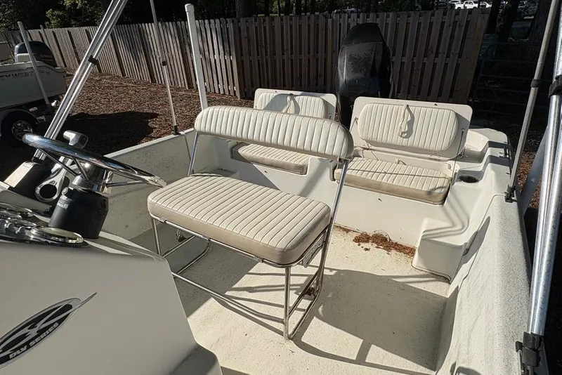 Slide: The Image of 2014 Carolina Skiff 218 DLV boat interior with seating and steering wheel. - 13
