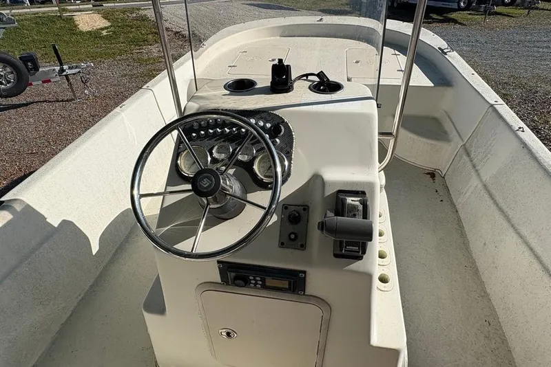 Slide: The Image of 2014 Carolina Skiff 218 DLV boat console with steering wheel and controls. - 15