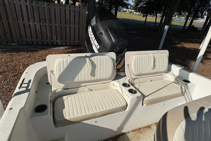 Slide: The Image of 2014 Carolina Skiff 218 DLV boat interior with dual seats and Suzuki outboard motor. - 16
