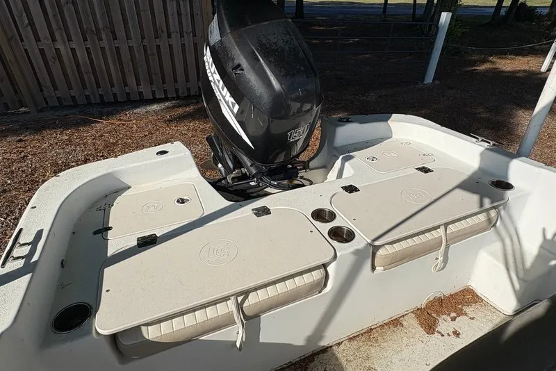 Slide: The Image of 2014 Carolina Skiff 218 DLV boat with Suzuki 150 outboard motor, rear deck view. - 17