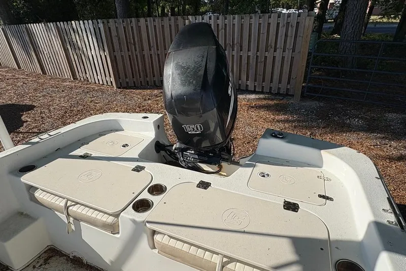 Slide: The Image of 2014 Carolina Skiff 218 DLV boat with Suzuki 150 outboard motor. - 18