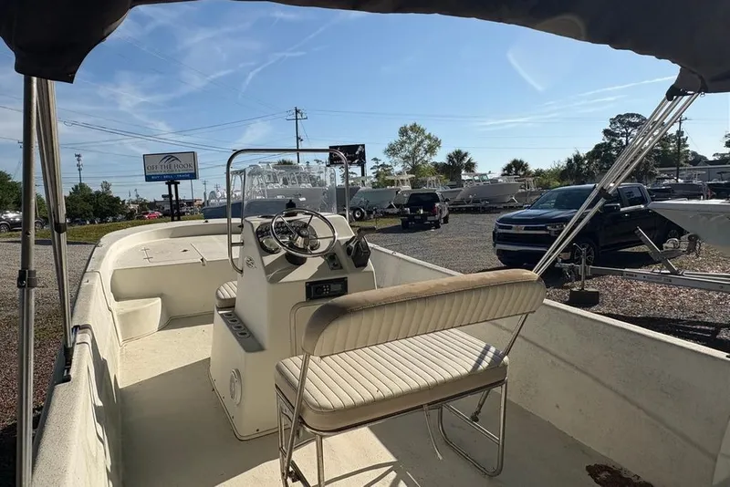 Slide: The Image of 2014 Carolina Skiff 218 DLV boat interior with steering console and seating. - 19