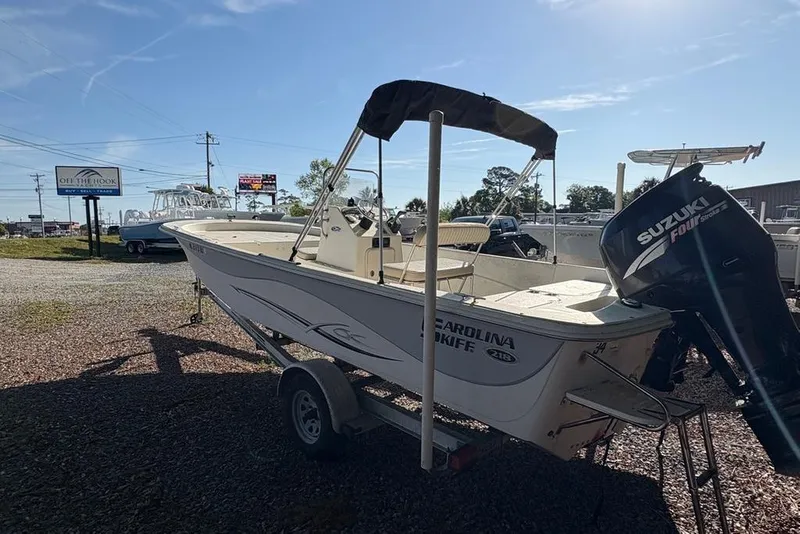 Slide: The Image of 2014 Carolina Skiff 218 DLV boat with Suzuki outboard motor on trailer. - 5