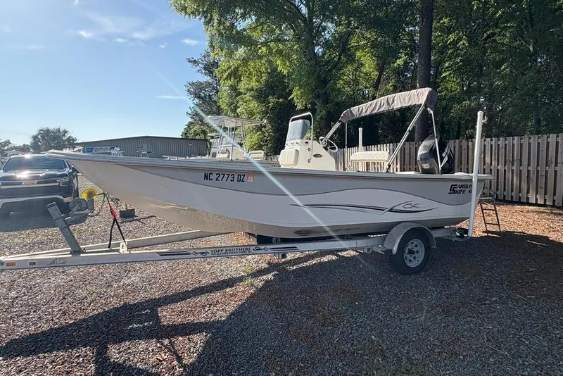 Slide: The Image of 2014 Carolina Skiff 218 DLV boat on trailer, parked outdoors. - 7