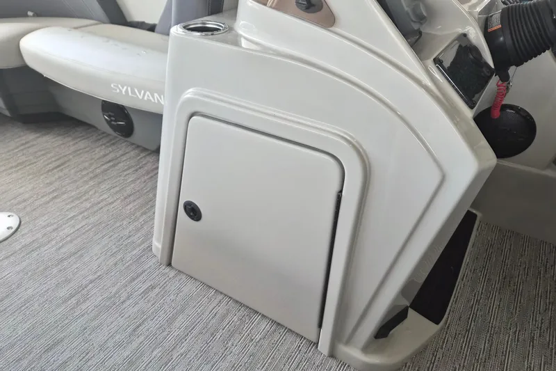 Slide: The Image of 2026 Sylvan Mirage Fish 820 Party Fish boat interior with storage compartment and seating. - 7