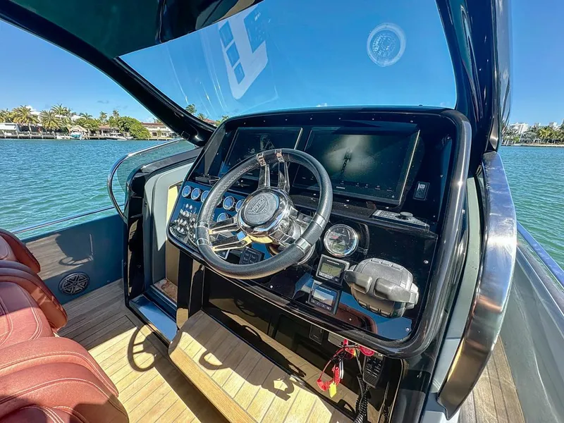Slide: The Image of 2019 SACS Rebel 40 helm with modern controls, steering wheel, and scenic water view. - 15