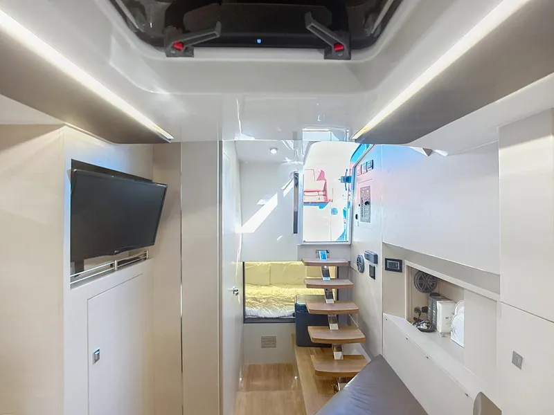 Slide: The Image of Interior of 2019 SACS Rebel 40 yacht, featuring modern design, TV, and wooden stairs. - 23