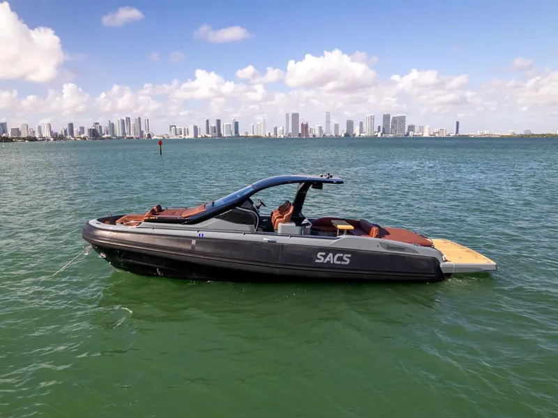 Slide: The Image of 2019 SACS Rebel 40 boat on water with city skyline in background. - 3