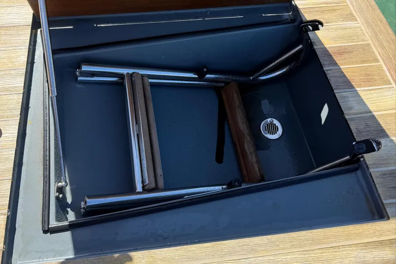 Slide: The Image of Foldable ladder compartment on 2019 SACS Rebel 40 boat deck. - 33