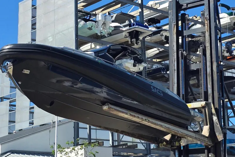 Slide: The Image of 2019 SACS Rebel 40 boat lifted by forklift in marina storage facility. - 41