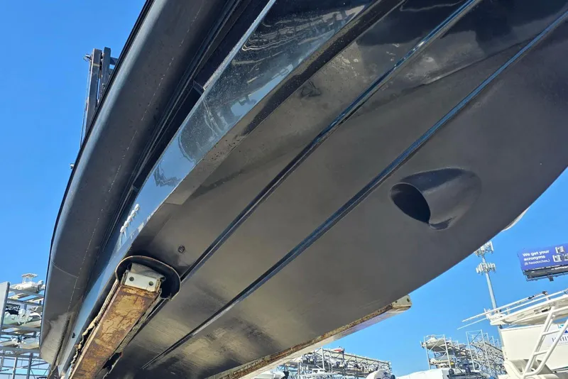 Slide: The Image of Underneath view of a 2019 SACS Rebel 40 boat hull against a clear blue sky. - 42