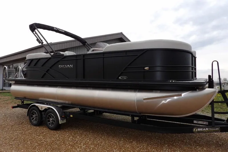 The Image of 2026 Sylvan 8522 LZ pontoon boat on trailer, parked outdoors. - 1