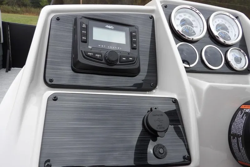 Slide: The Image of Dashboard of 2026 Sylvan 8522 LZ boat with audio system and gauges. - 16