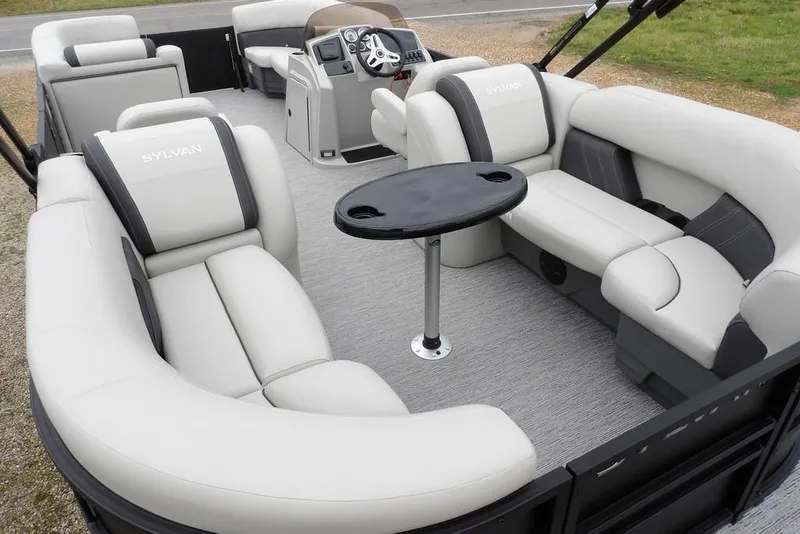 Slide: The Image of Luxurious interior of 2026 Sylvan 8522 LZ pontoon boat with plush seating and table. - 26