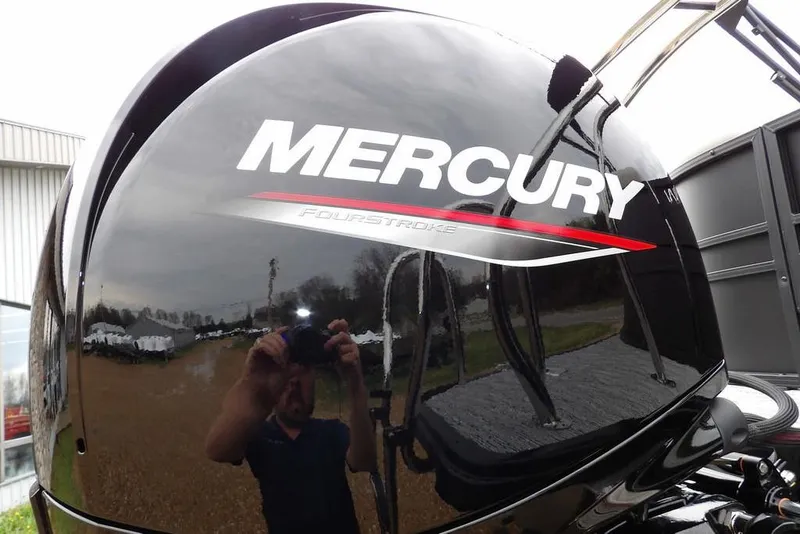 Slide: The Image of Mercury FourStroke engine on 2026 Sylvan 8522 LZ boat, reflecting outdoor scenery. - 28