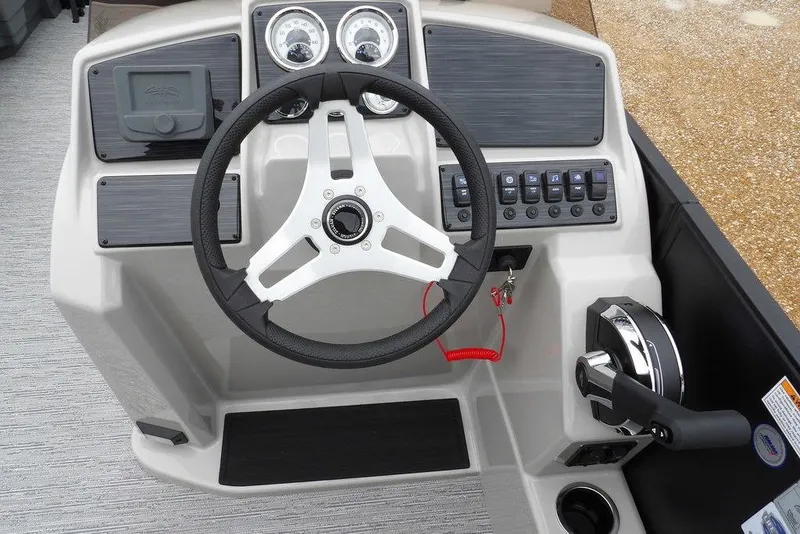 Slide: The Image of 2026 Sylvan 8522 LZ boat dashboard with steering wheel and control panel. - 29