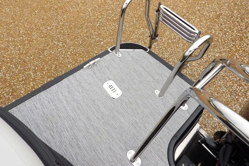 Slide: The Image of 2026 Sylvan 8522 LZ boat deck with stainless steel ladder and textured flooring. - 32