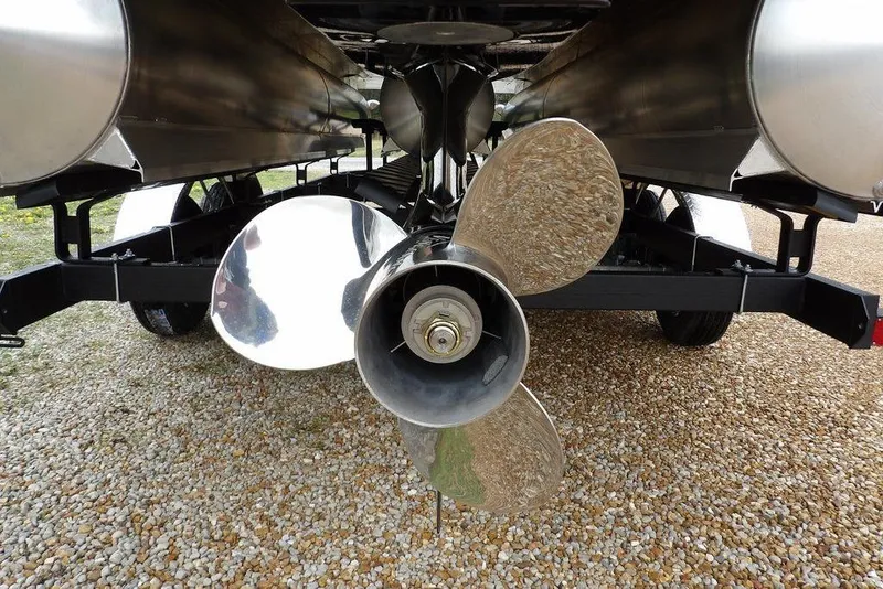 Slide: The Image of Propeller of 2026 Sylvan 8522 LZ pontoon boat on gravel surface. - 38