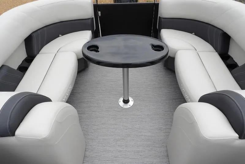 Slide: The Image of Luxurious seating area on 2026 Sylvan 8522 LZ pontoon boat with central table. - 41