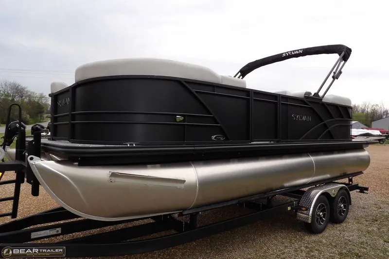 Slide: The Image of 2026 Sylvan 8522 LZ pontoon boat on trailer, sleek black design. - 8