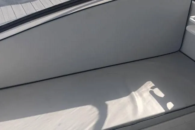 Slide: The Image of Interior seating of a 2000 Luhrs Tournament 290 Open boat, featuring sleek white upholstery. - 11