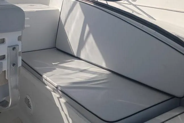 Slide: The Image of Interior seating of 2000 Luhrs Tournament 290 Open boat, featuring cushioned bench. - 12